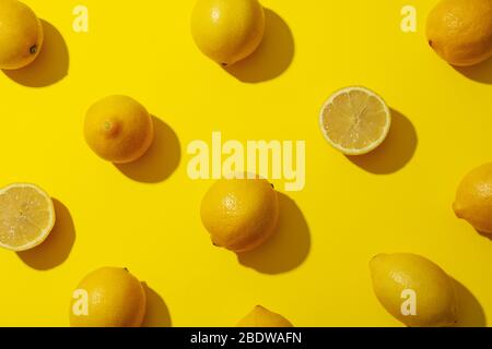 Flat lay composition with lemons on yellow background Stock Photo