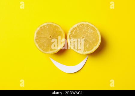 Smiley face made of lemons on yellow background Stock Photo