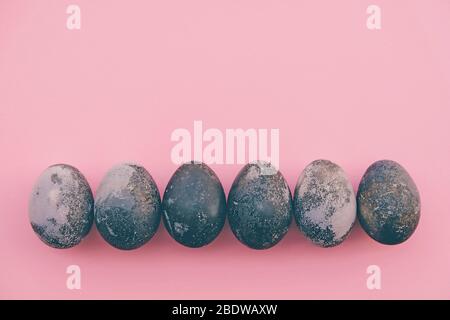 Natural dyed colored eggs on pastel pink background, top view. Flat lay. Happy Easter. Space for text. Stock Photo