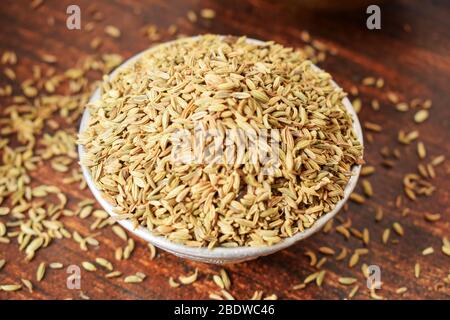 Dried Fennel Seeds in a Silver bowl on wooden old Table. Rustic Style Stock Photo