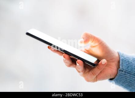 Beautiful hand holding mobile phone Stock Photo
