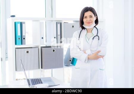 Beautiful doctor wearing uniform in light office Stock Photo