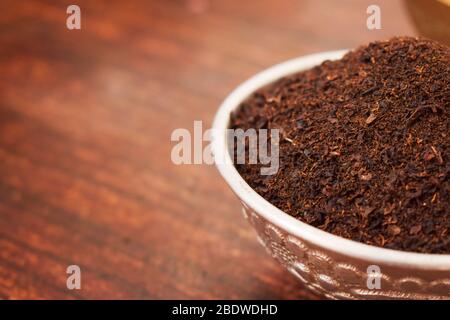 Dry Tea in a Silver bowl on wooden old Table. Rustic Style Stock Photo