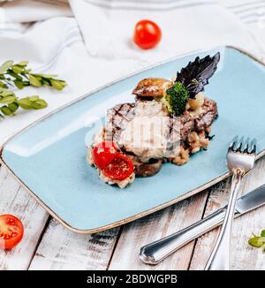 fried meat with mushroom sauce in the plate Stock Photo