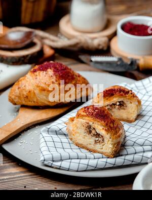 pies with meat from puff pastry sprinkled with sumac on a plate Stock Photo