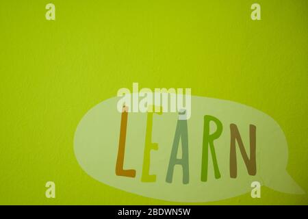 Word Learn in the cloud circle. Children design. Colored wall background. Copy space Stock Photo