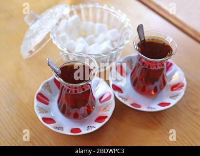 traditional turkish tea with sugar cubes on wooden table Stock Photo