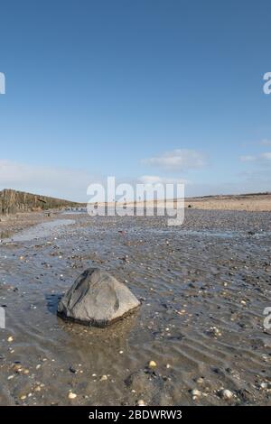 A soothing picture of the wadden sea at paesens moddergat, big rock in foreground, sea and sky. Stock Photo