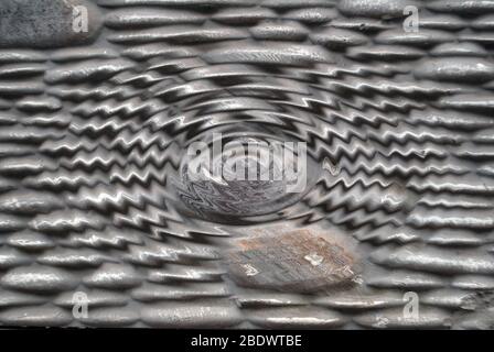 Gray texture background, sandstone masonry stone with a swirling center Stock Photo