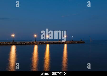 Paralia seaside promenade with lanterns, buildings and lighthouses in the port Stock Photo