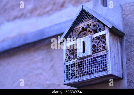 Handmade insect hotel out of wood in the garden. Stock Photo