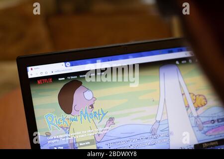 New York, USA - 9 April 2020: Netflix Rick and Morty website on laptop screen close up. Man using service on display, blurry background, Illustrative Stock Photo