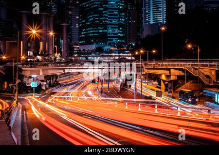 city road traffic at night, light trails of cars on street in Hongkong Stock Photo