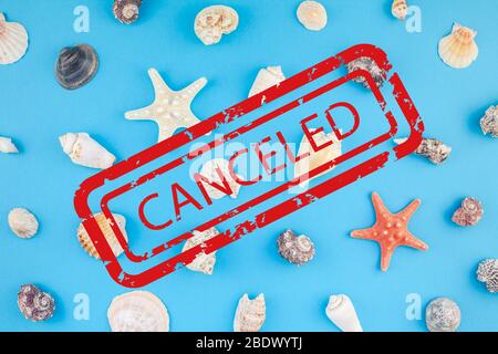 Pandemic lockdown concept. Creative flat lay pattern of summer travel vacations. Top view of seashells and starfish on turquoise blue background with Stock Photo