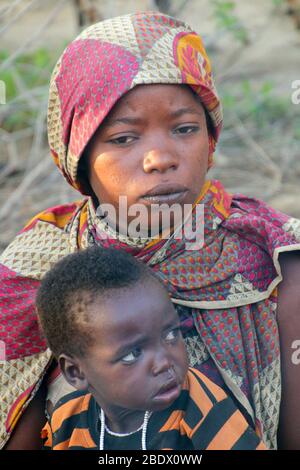 Portrait of a young Hadza mother with her baby, Hadza or Hadzabe is a small tribe of hunter gatherers. Photographed at Lake Eyasi, Tanzania Stock Photo