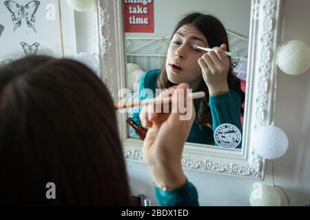 Teenage girl putting on make-up during Covid19 confinement in Catalonia, Spain