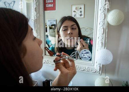 Teenage girl putting on make-up during Covid19 confinement in Catalonia, Spain