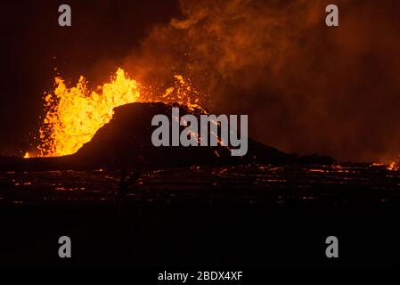 Lava erupts from a fissure in the Leilani Estates neighborhood at night, May 23, 2018. Stock Photo