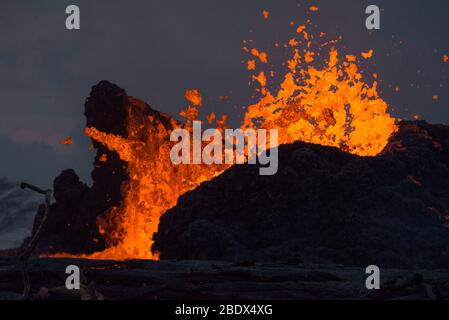 Lava erupts from a fissure in the Leilani Estates neighborhood at dusk, May 23, 2018. Stock Photo