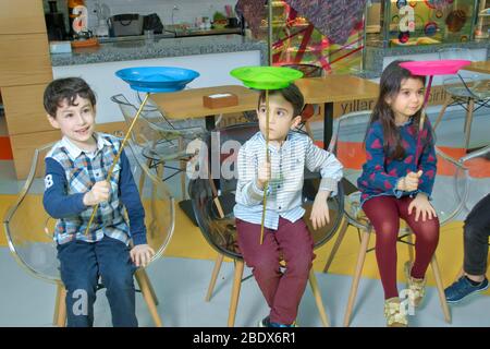 Fun with Spinning Plates .balancing a spinning plate. Kids learning how to play spinning plate, Preschool boy balancing bolw on wooden pole . Child Stock Photo