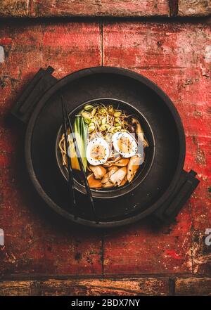 Ramen soup with chicken and shiitake mushrooms in black bowl Stock Photo