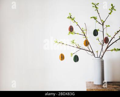 Easter holiday tree branches with festive eggs, copy space Stock Photo
