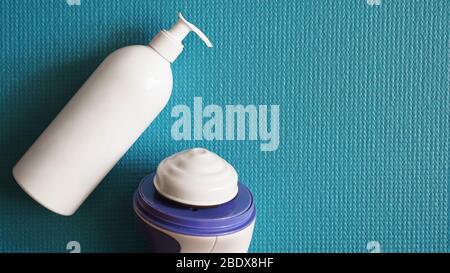 Lotion and anti-cellulite massager on a blue background. Healthy and beautiful skin concept. Stock Photo