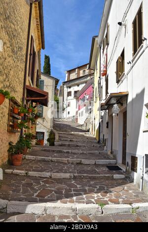 A narrow street between the houses of Pescosolido, a medieval village in Italy Stock Photo