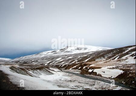 West fjords landscape, Iceland. Snow covered mountains, moody, cloud sky Stock Photo