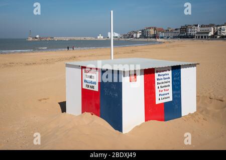 Chalk writing telling people to stay away from Margate Beach is visible on an empty beach in Margate, Kent, during the Easter bank holiday weekend, as the UK continues in lockdown to help curb the spread of the coronavirus. Stock Photo