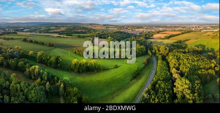 Gorgeous aerial landscape panorama after sunrise: European meadows and forests with blue sky and leading lines Stock Photo
