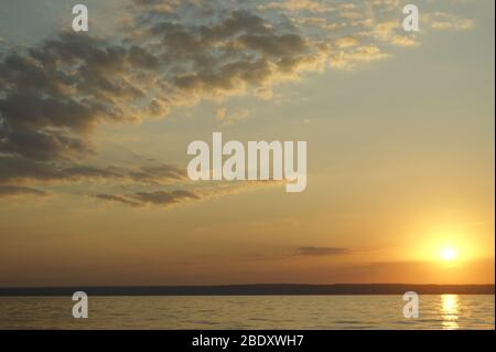 Gradient cloudy sunset off the coast of the great Russian river Stock Photo