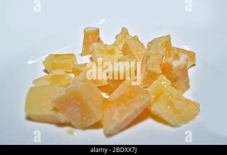 Cheese chunks on white Stock Photo - Alamy