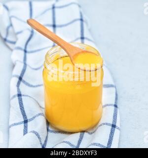 Closeup image of indian ghee (clarified butter) with wooden spoon Stock Photo