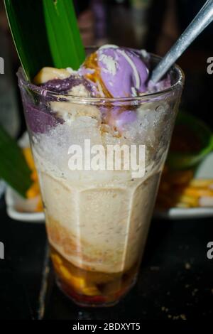 Filipino Dish named halo halo. This is a mix of fruits with ice cream and sweets mixed with crushed ice and milk Stock Photo