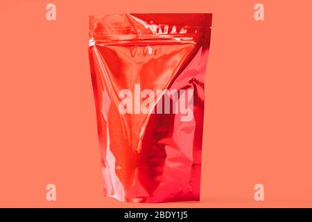 shiny red angle view of food doypack stand up pouch with zipper on red background Stock Photo