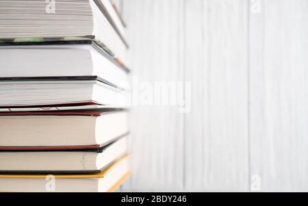 Book stack on white wooden table. Top view bright background of home library with space for text. World Book Day Stock Photo