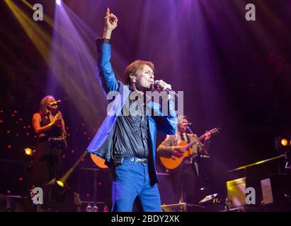 Cliff Richard performs at the Royal Albert Hall. He is the third top selling artist in the UK behind the Beatles and Elvis Presley. Stock Photo