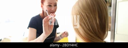 Cheerful young woman working with blonde lady Stock Photo