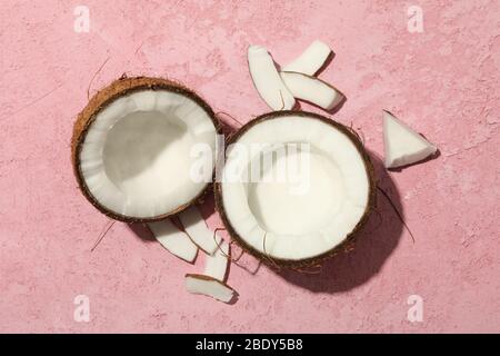 Coconut on pink background, top view. Tropical fruit Stock Photo