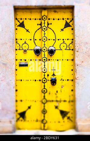Spiked wooden door in the medina. Stock Photo