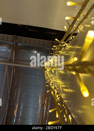 Fairy lights on a pole. Picture taken from the foot of the pole Stock Photo