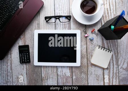 digital tablet, laptop, smart phone notepad, and tea on wooden table  Stock Photo