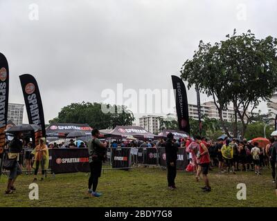 APRIL 27, 2019:SINGAPORE SINGAPORE : Crowd getting ready for the marathon on a cloudy day in Singapore. Spartan kids banner and tents stationed around Stock Photo