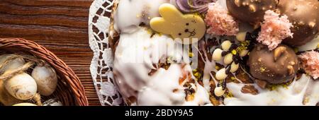 Fruit Easter Bunny cake with sweet glaze, pink marshmallow, chocolate bunny on wooden background, Easter Holiday, Easter decor. Stock Photo