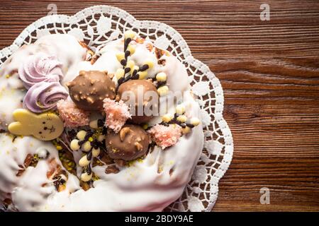 Fruit Easter Bunny cake with sweet glaze, pink marshmallow, chocolate bunny on wooden background, Easter Holiday, Easter decor. Stock Photo