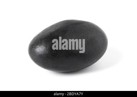 Black smooth stone close up isolated on white Stock Photo