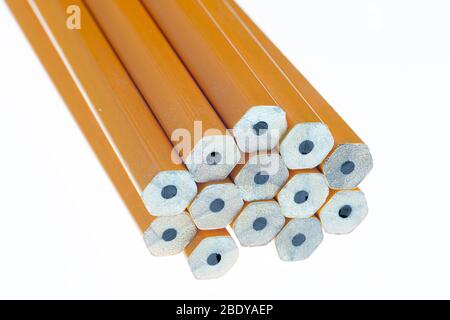 Horizontal close-up shot of the lead end of a group of pencils.  The pencils are not sharpened.  Pointing toward the camera.  White background. Stock Photo