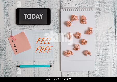 Word writing text Feel Free. Business photo showcasing have no hesitation or shyness often used as an invitation Squared spiral notebook marker smartp Stock Photo