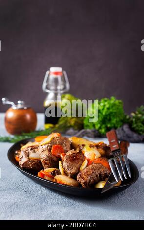 fried potato with liver on metal plate Stock Photo